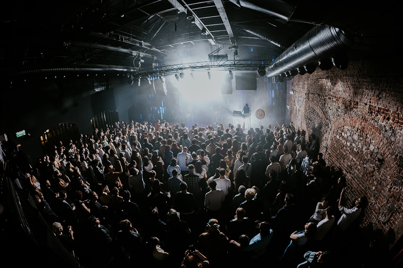 Vibrant concert crowd in Istanbul under neon lights